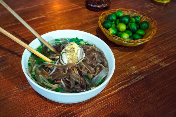 istock Balut boiled developing duck embryo is a special cuisine in Asia. it's very popular in Philippine, Vietnam, Lao and Cambodia. An exotic soup with Pho noodles on the table in the restaurant. 1148755849