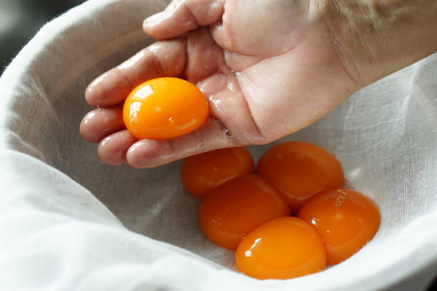 istock Using hand to separate egg yolk from egg white, prepare food for cooking. 1148756172