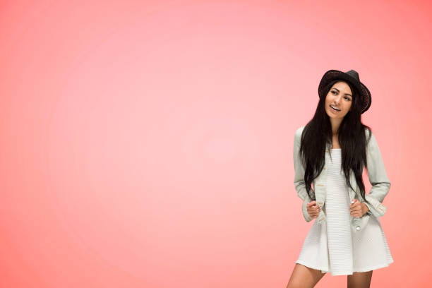 istock Beautiful female on pink background is looking trendy 1148757565