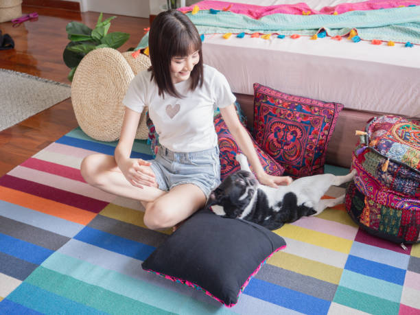 istock Women playing with dogs on the floor 1148757755