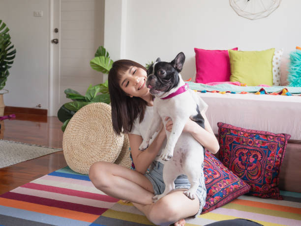 istock Women playing with dogs on the floor 1148757918