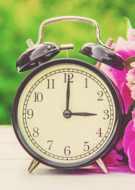 istock Spring flowers and Alarm Clock. Change the time. 1148757961