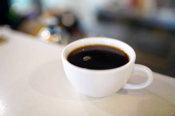 istock A cup of black coffee on table and blurred background, Perfect for breakfast time. 1148758597