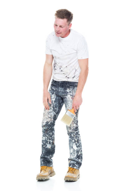 istock Young attractive male painter standing on white background - tired 1148758600