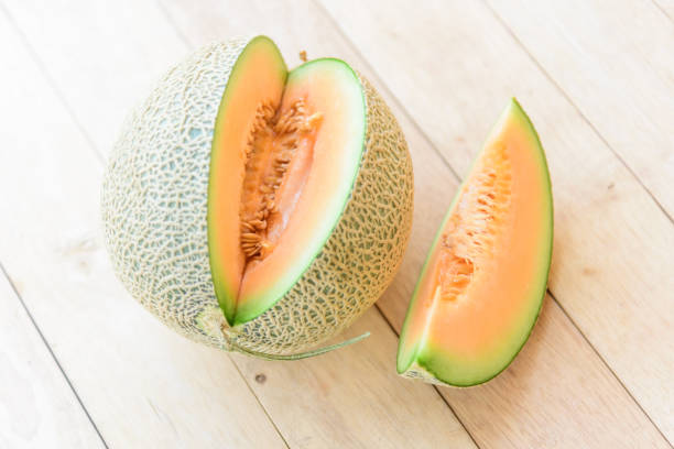 istock use knife split the orange melon on wood plate 1148758932