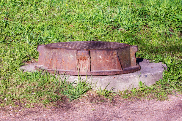 istock manhole on the green lawn 1148759143