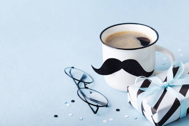 istock Creative breakfast on Happy Fathers Day with gift or present box and funny face from cup of coffee and moustache. 1148761263