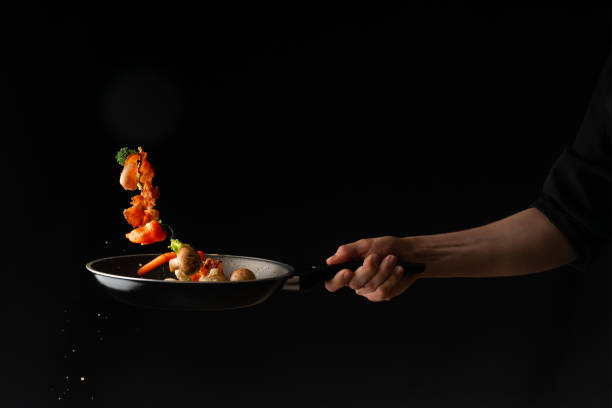 istock Cook preparing bacon slices with garlic and hot pepper and broccoli in a pan 1148763021