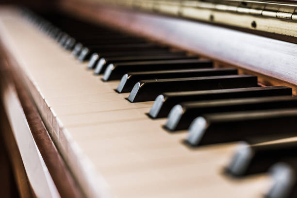istock Rustic piano: close up picture of classical piano keys, selective focus 1148763024