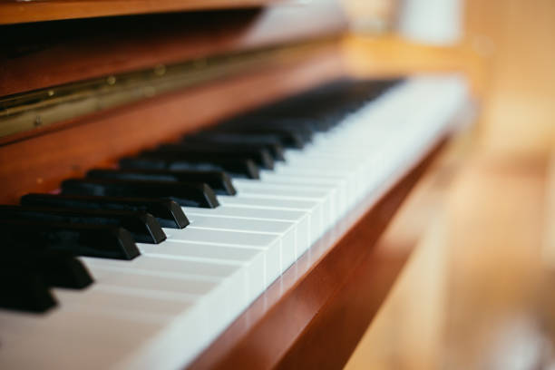 istock Rustic piano: close up picture of classical piano keys, selective focus 1148763525
