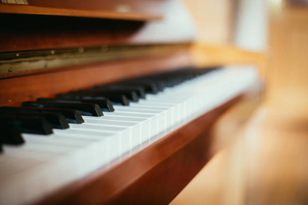 Rustic piano: close up picture of classical piano keys, selective focus