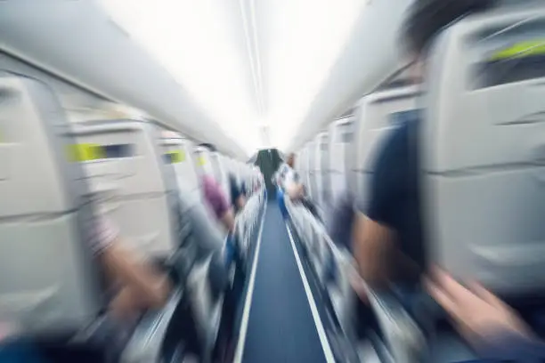 Photo of aerophobias concept. plane shakes during turbulence flying air hole. Blur image commercial plane moving fast downwards. Fear of flying. collapse slump, depression, downfall, debacle, subsidence. dive.