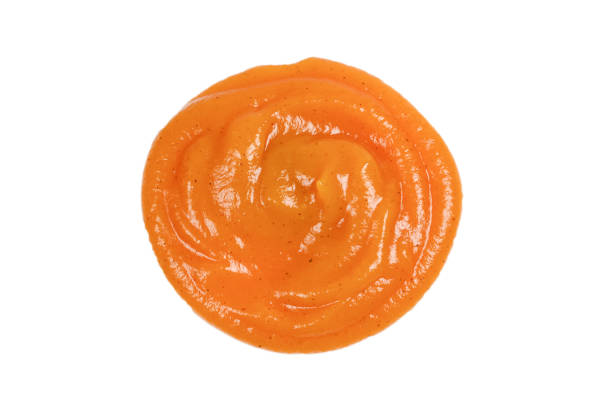 istock Orange sauce splashes isolated on white background 1148767325