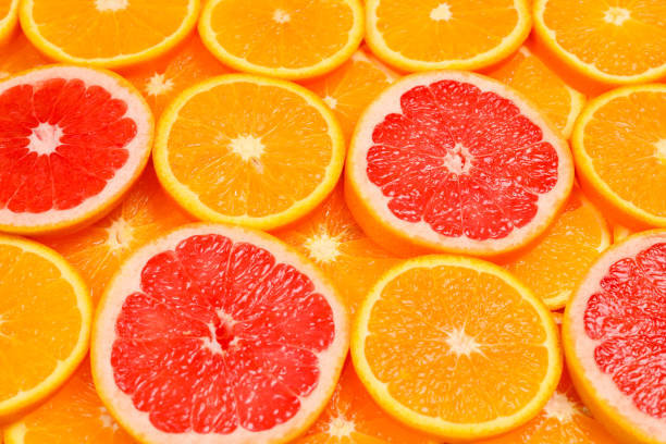 istock Slices of oranges and a grapefruits as a background. 1148767891