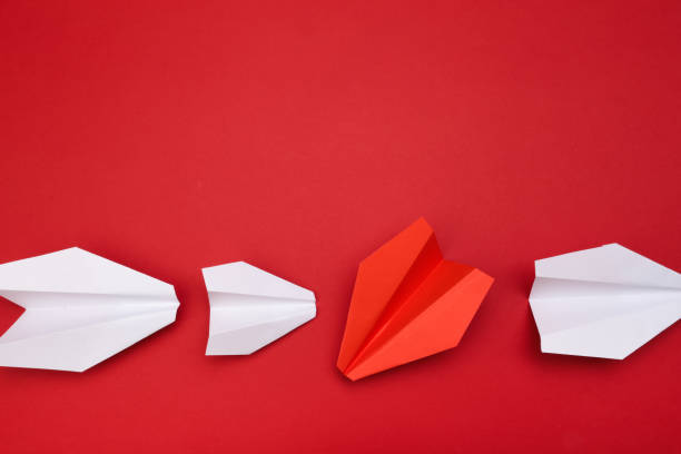 istock winner red  paper aircraft on red background - Image 1148767984