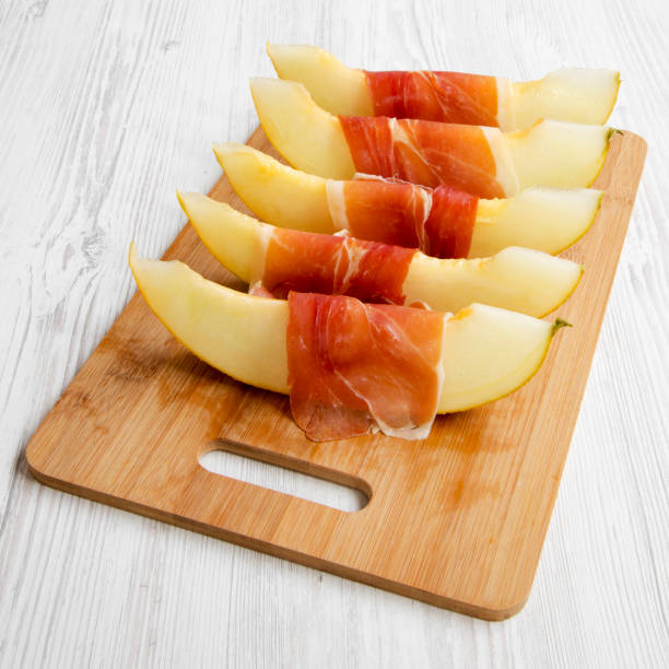 istock Melon slices wrapped in prosciutto, low angle view. Close-up. 1148769156
