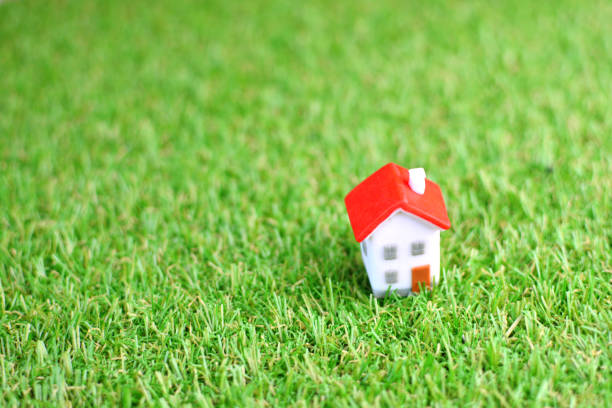 istock Miniature toy house on artificial grass 1148769257