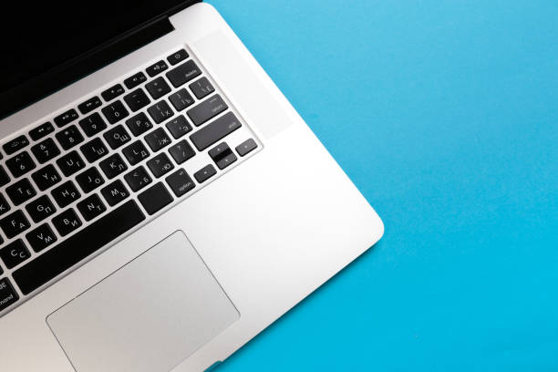 istock laptop on blue background flat lay place - Image 1148769436