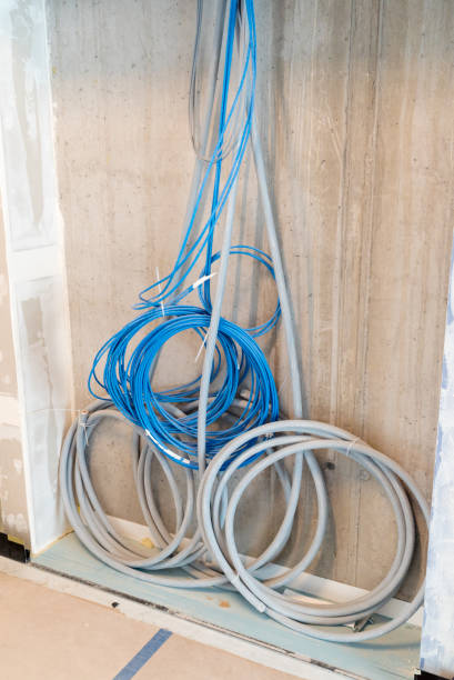 istock gray and blue electrical cables hanging on a wall in spirals and bundles 1148769511