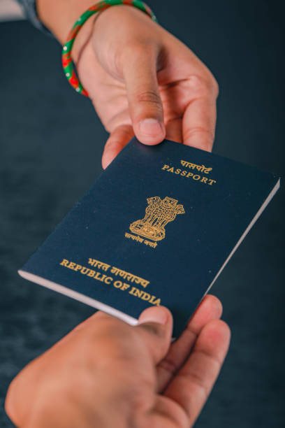 istock indian passport  in hand , showing passport 1148773587