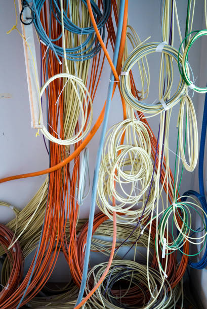 istock colorful electrical cables hanging from the ceiling in spirals and bundles 1148773657