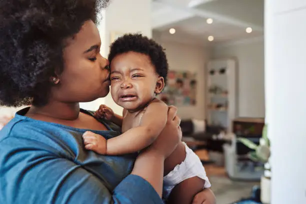 Shot of an adorable baby girl bonding with her mother at home