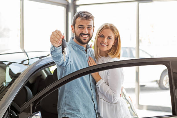 istock Couple buying new car 1148774426