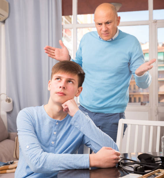 istock Man scolding son at home 1148774724