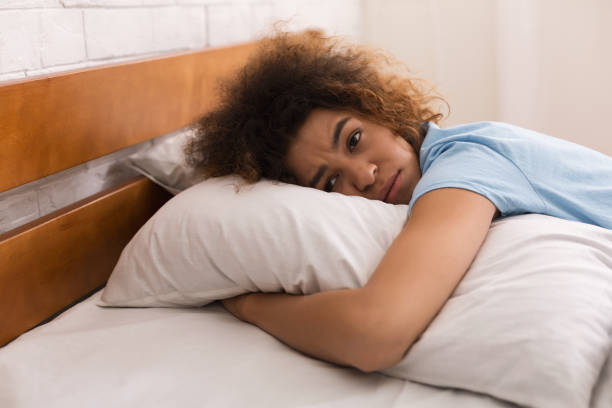 istock Worried girl hugging pillow and having depressing thoughts 1148775233