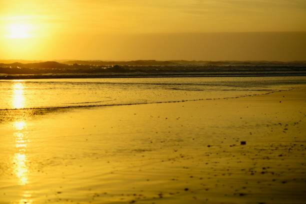 istock Dramatic sunset colours; beautiful sunset on a beach. Sun reflection in the water. 1148776965