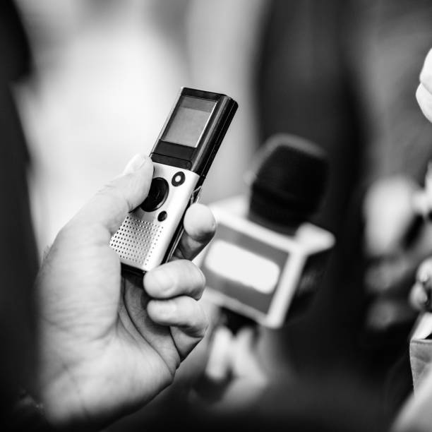 istock Midsection Of Journalist Holding Microphone 1148777027