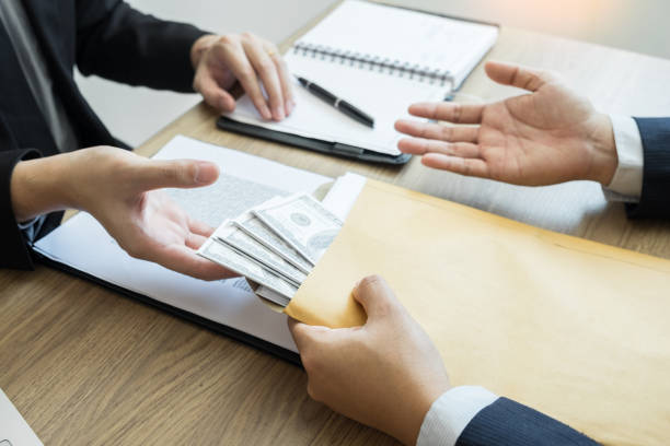 istock Midsection Of Businessman Receiving Bribe From Client At Office 1148777036