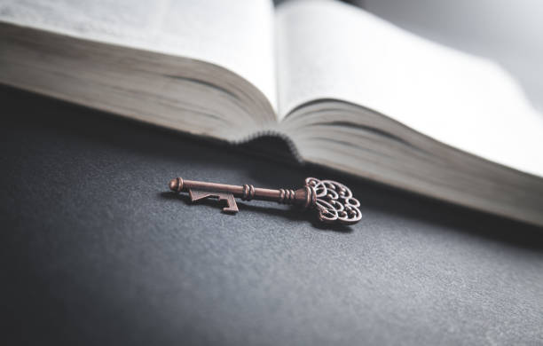 istock Old key with bible. Concept of wisdom and knowledge 1148780875