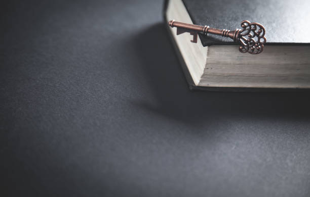 istock Old key with bible. Concept of wisdom and knowledge 1148780882