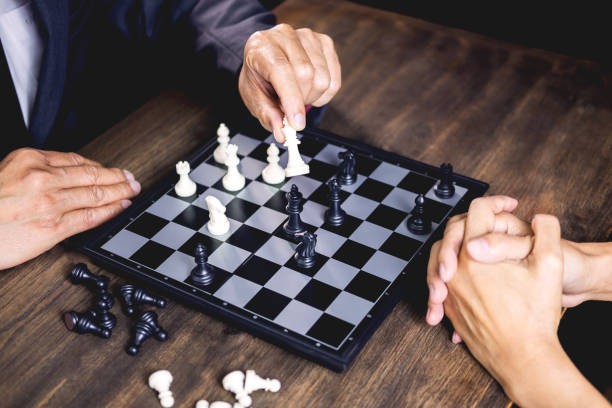 istock Midsection Of Man Playing Chess With Friend 1148781608