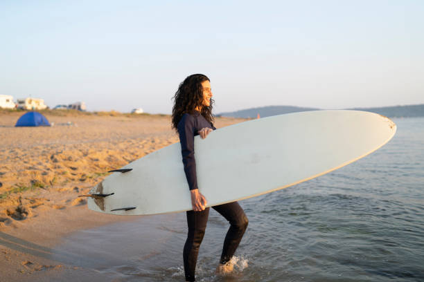istock Female surfer going to water 1148782110