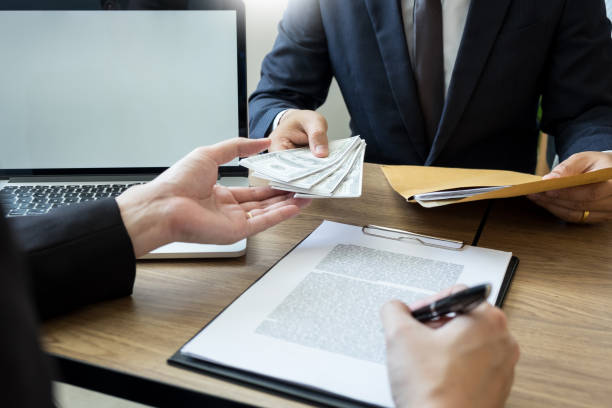 istock Midsection Of Client Giving Bribe To Businessman At Office 1148784033