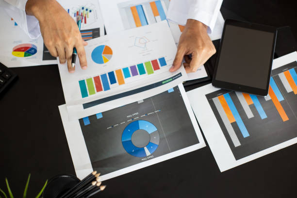 istock Midsection Of Businessman Working Over Graph On Table 1148785453