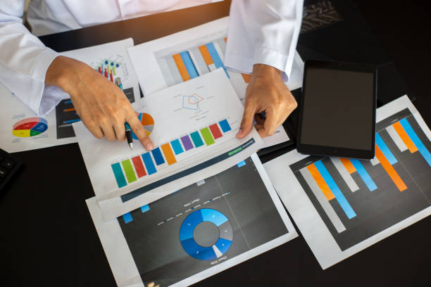 istock Midsection Of Businessman Holding Graph Chart At Office 1148785502