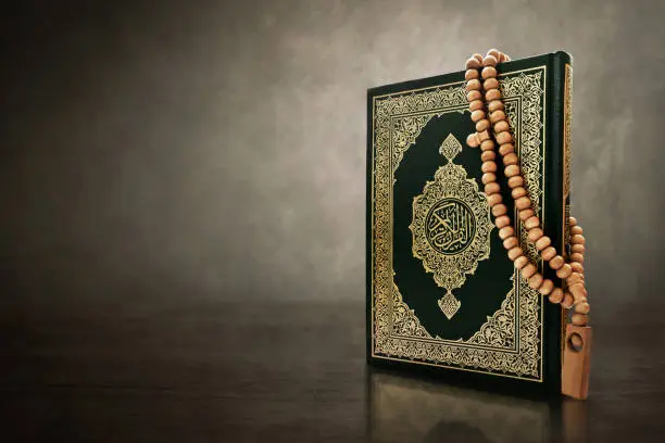 Quran holy book with prayer beads beads