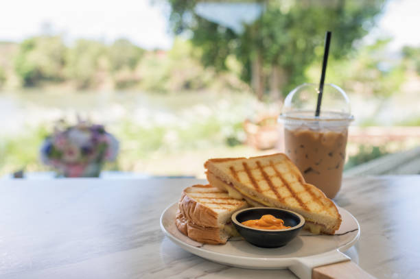 istock Ham cheese sandwich with custard sauce and ice coffee on marble 1148788782