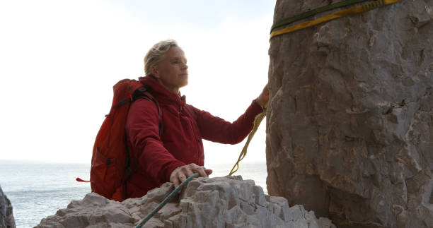 istock Female mountaineer reaches pinnacle 1148791673