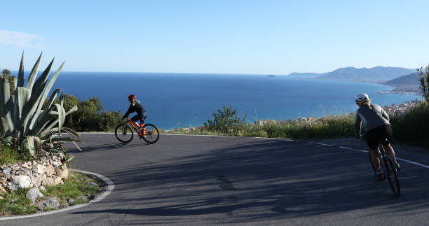 istock Female bicyclists ride along coastal road 1148791709
