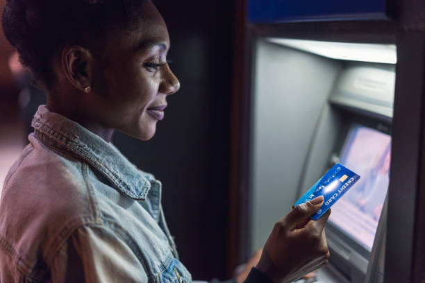 istock Beautiful woman at the ATM device 1148791759