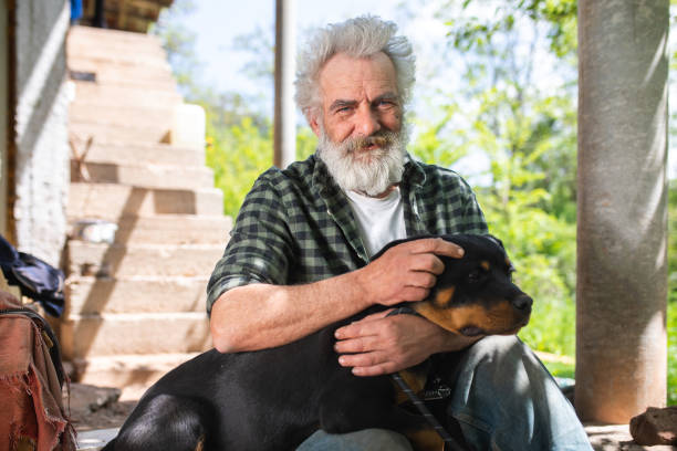 istock Senior man resting after a hard day while petting his dog 1148792890
