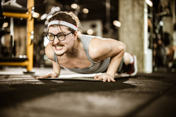 istock Nerdy male athlete making an effort while exercising push-ups in a gym. 1148794645