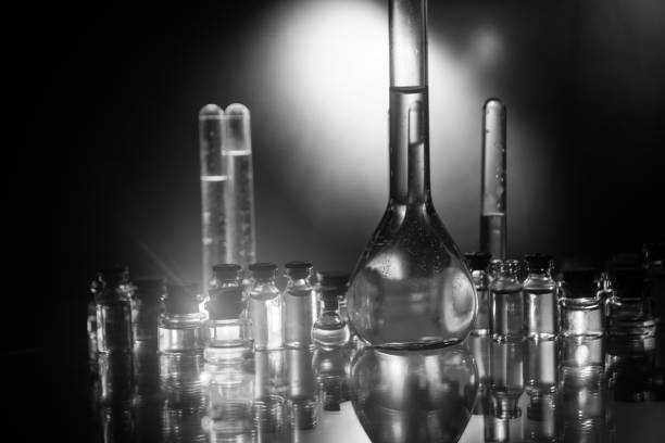 istock Pharmacy and chemistry theme. Test glass flask with solution in research laboratory. Science and medical background. Laboratory test tubes on dark toned background 1148794821