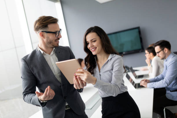 istock Happy young business colleagues in modern office 1148794946
