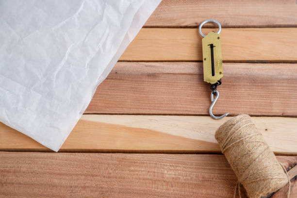 Brown paper parcel torn open in an untidy manner.  Alternative version shown below: