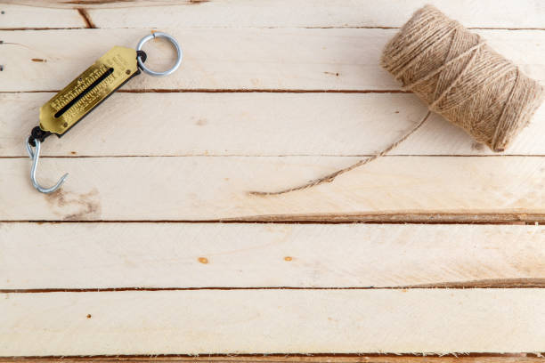 istock manual scales and a thread for wrapping on wooden background 1148795226